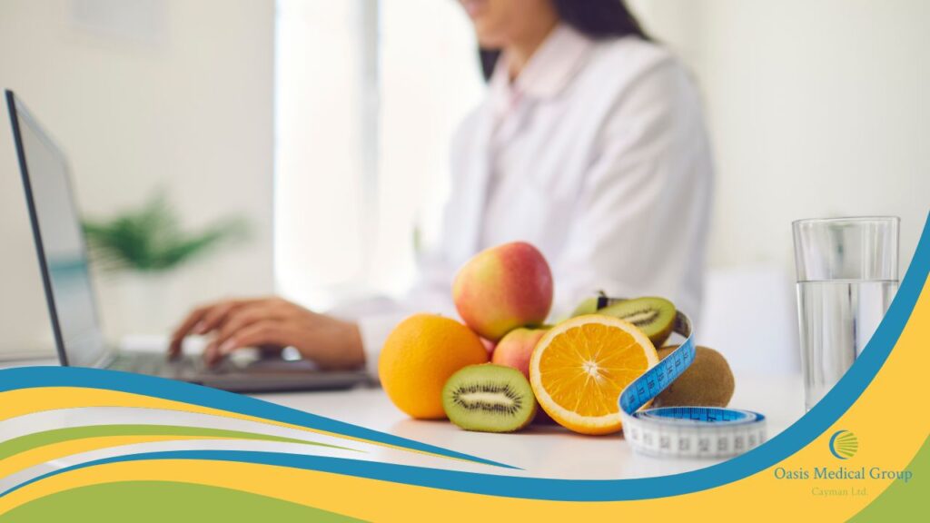 Dietitian in front of computer with fruits, water, and tape measure