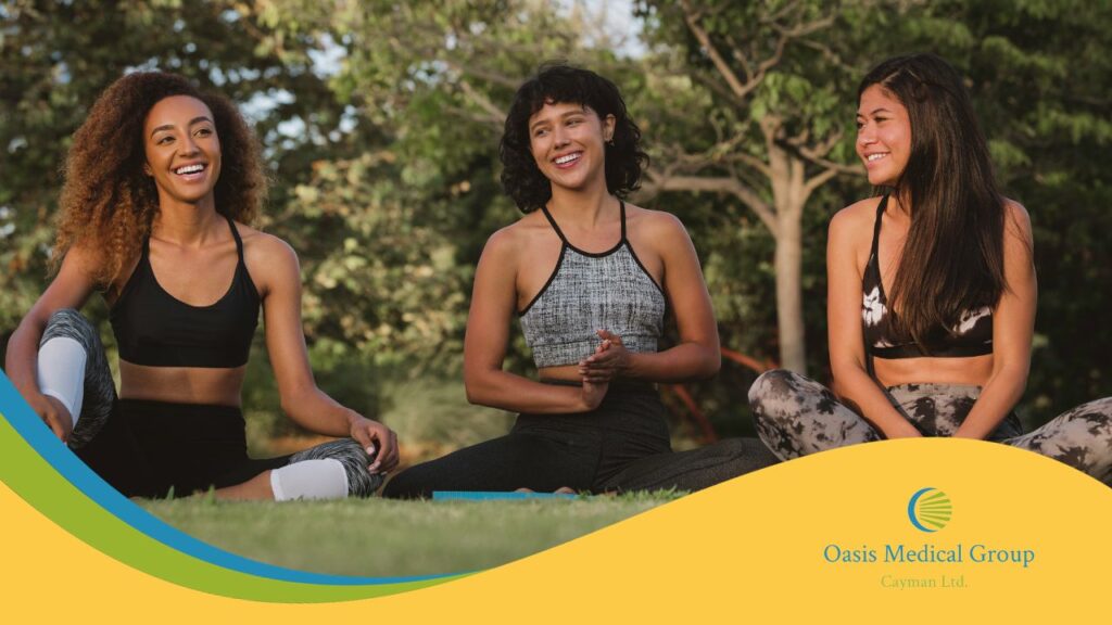 Three diverse women laughing and exercising outdoors.