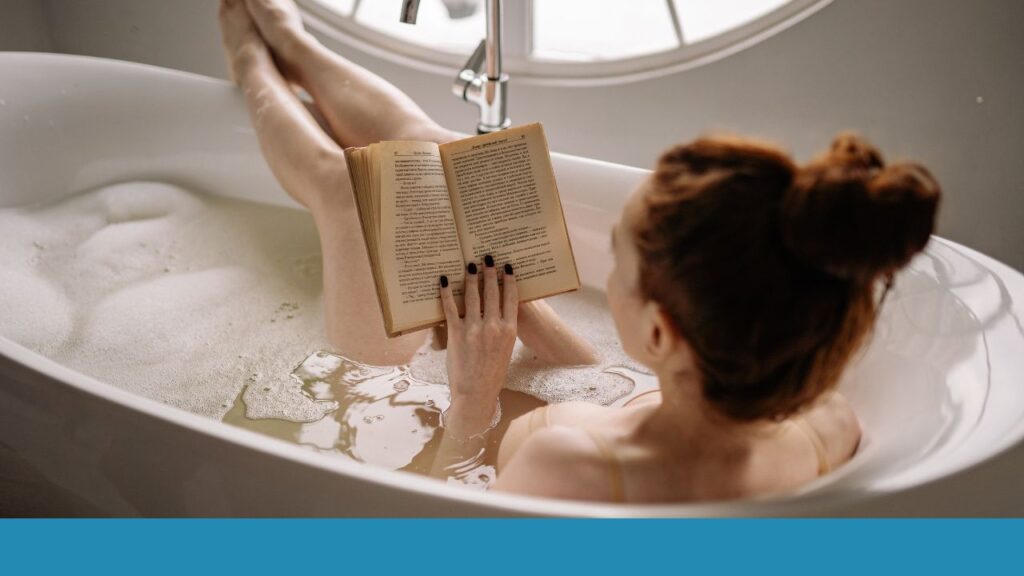 woman reading while in the bath tub